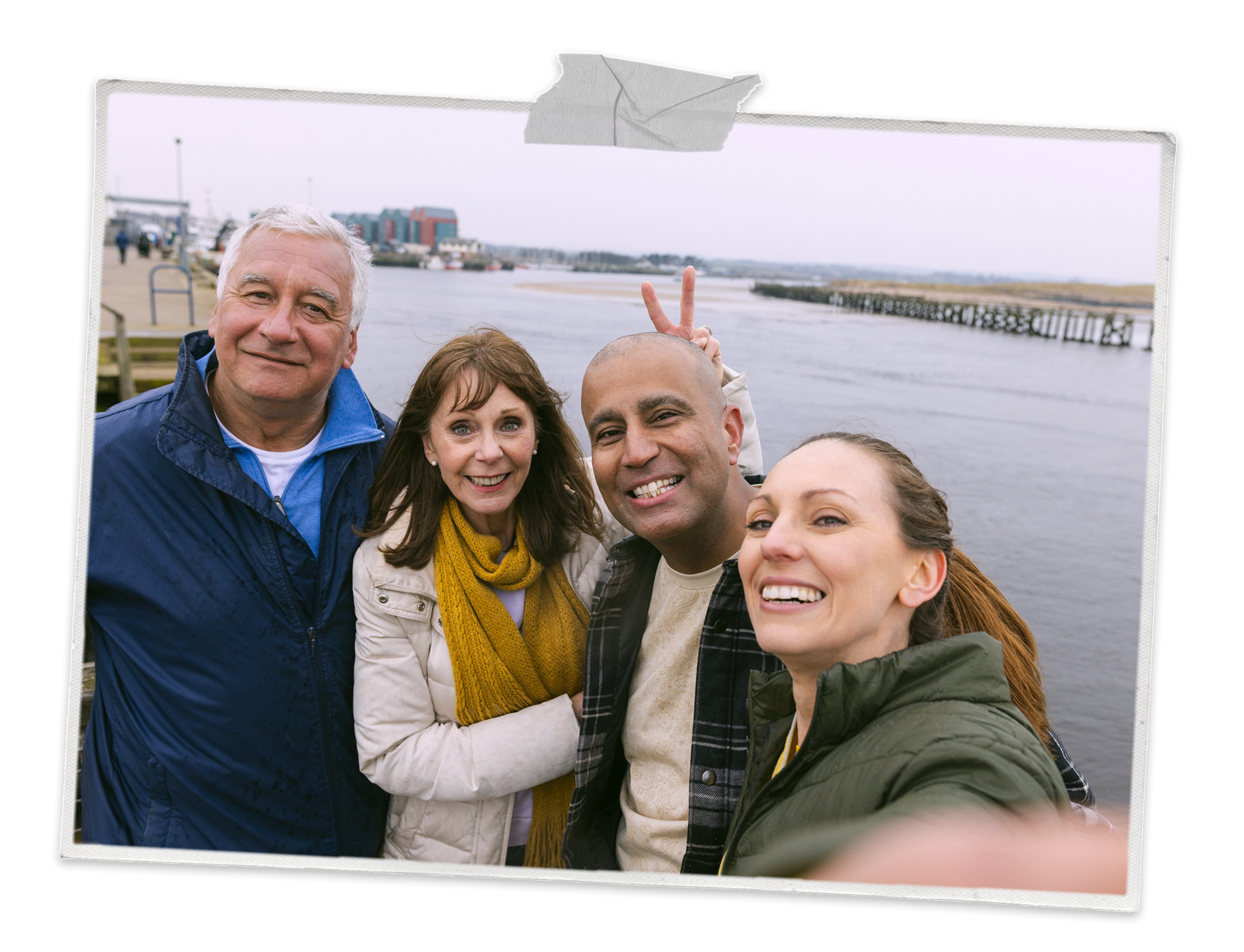 Two couples taking a selfie on a pier
