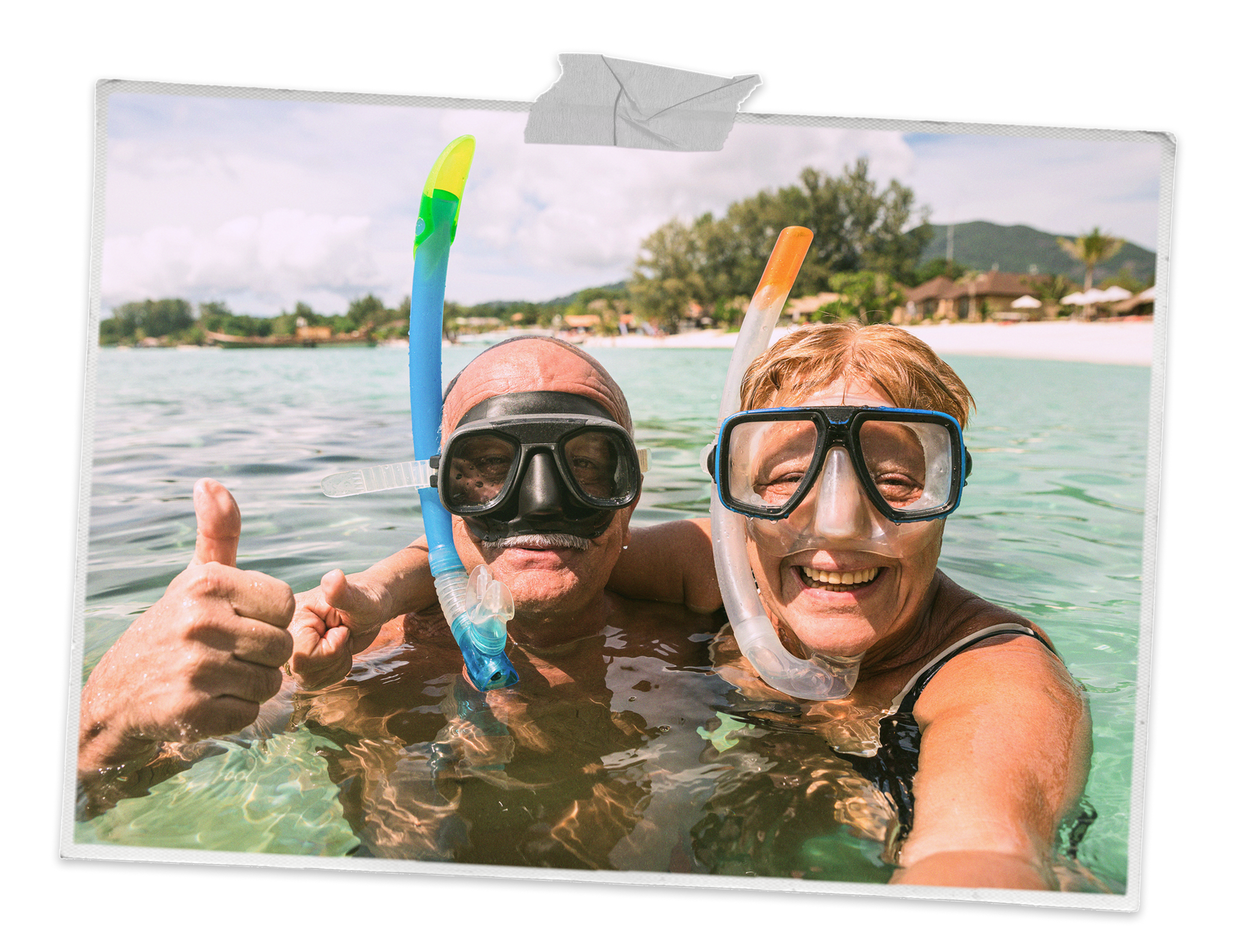 A senior couple taking a selfie while snorkelling in a tropical sea