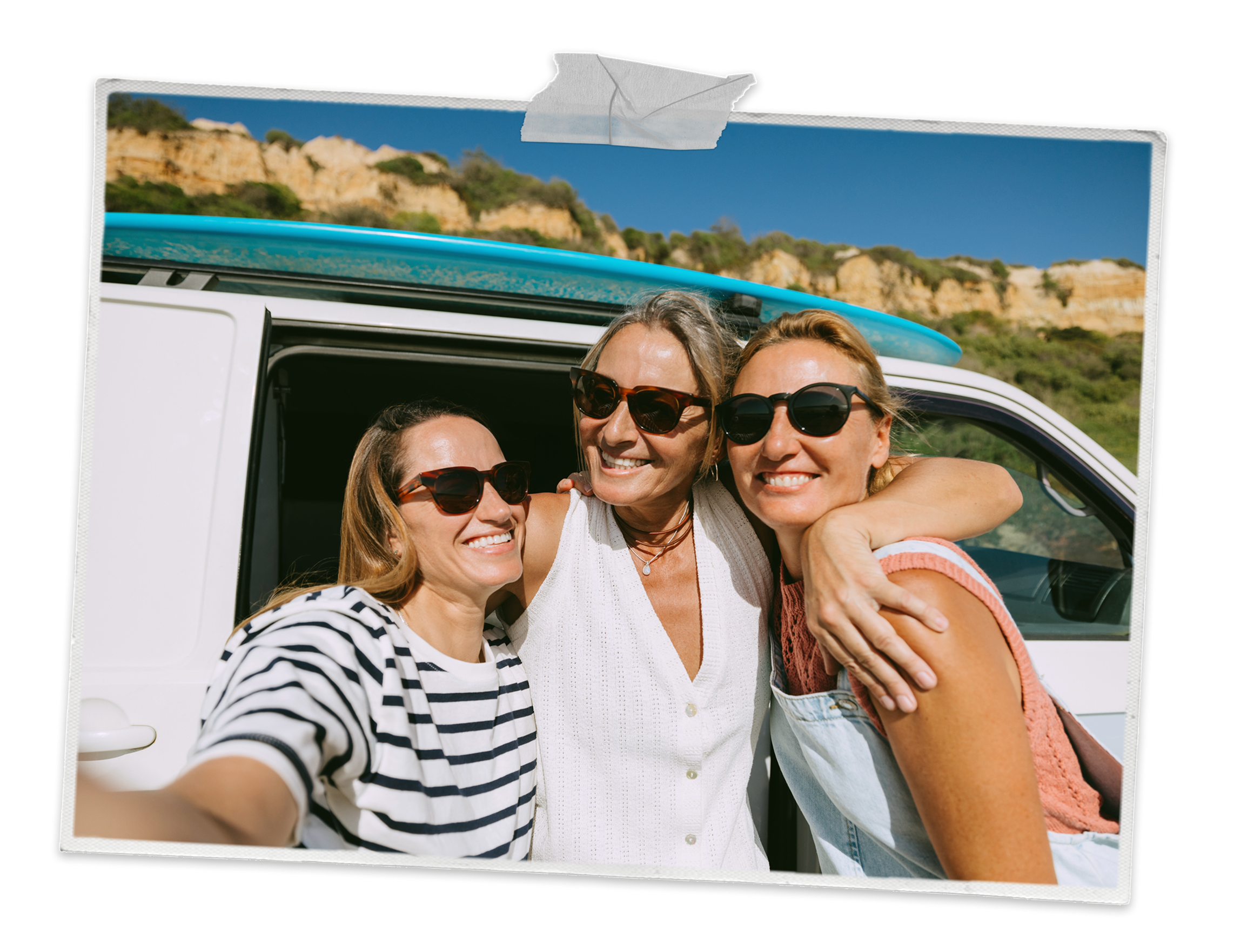 Friends smiling in front of a camper van